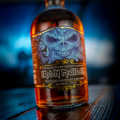 Bottle of Iron Maiden rum with a skull design on the label, set against a blurred background.